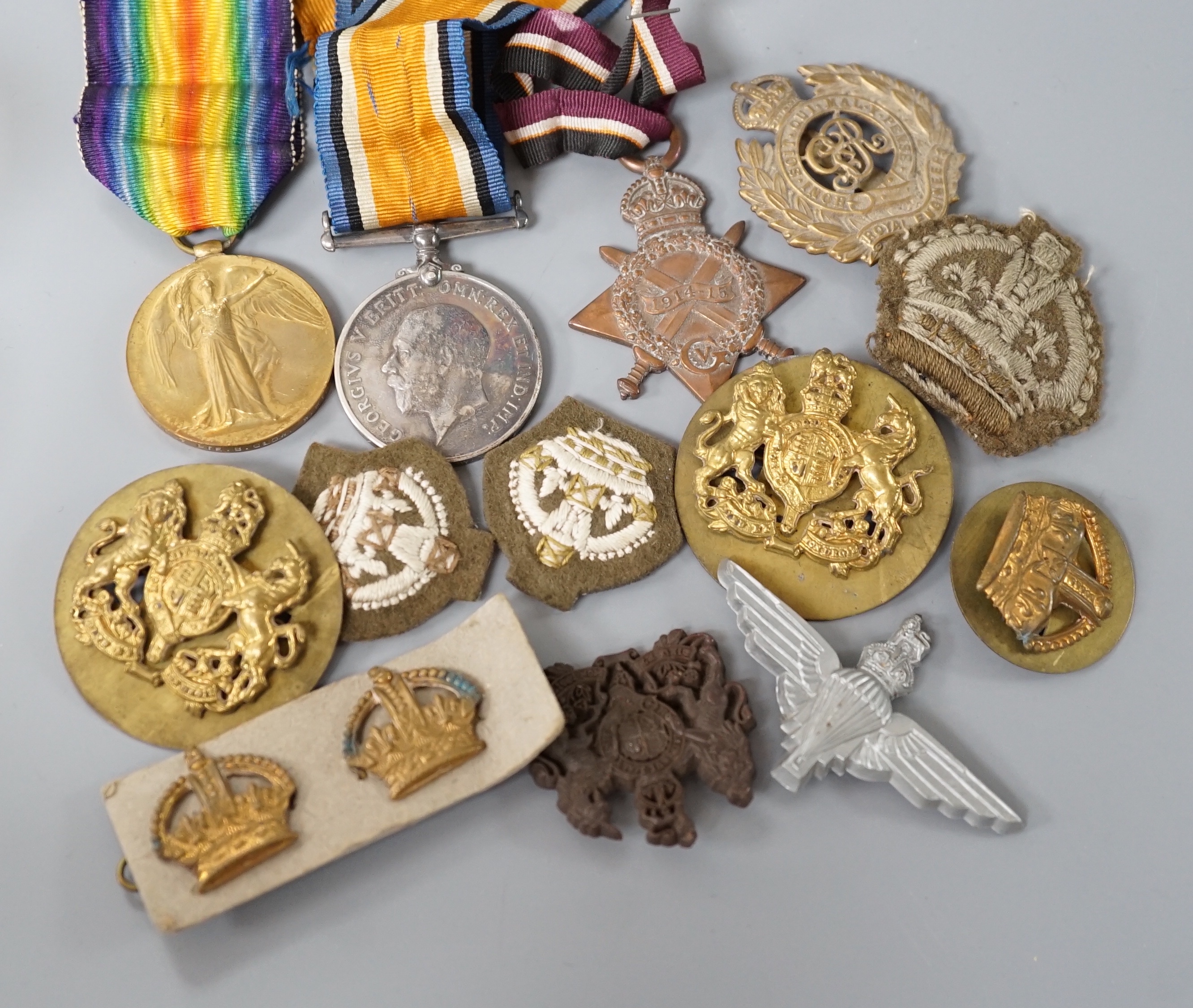 Two WWI medals, collection of cap badges and buttons, Queen Mary tobacco tin and a 66th Infantry Brigade concert party clickety clack cigarette case etc